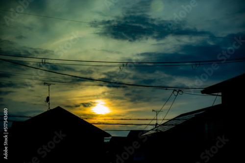 Silhouette of electric cables and towers at sunset time © Karori Production
