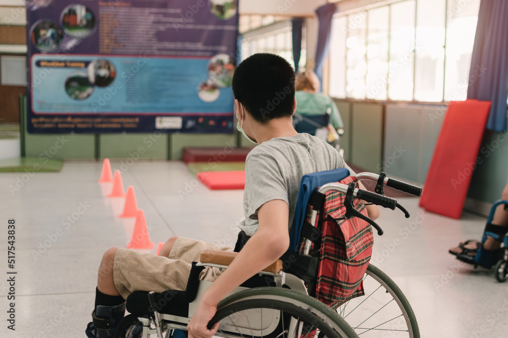 Obraz premium Young man with disability practicing wheelchair by an occupational therapist teacher on ramps for people with disabilities,Lifestyle in the education age and practicing essential skills in daily life.