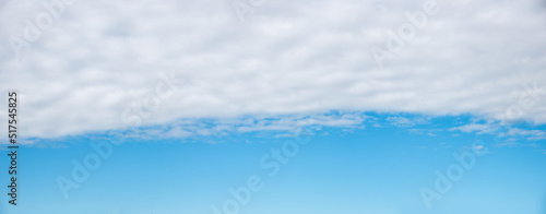 blue sky background with light grey cloud overcast in the upper half