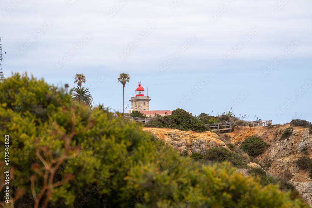 Lighthouse sourrounded with trees at Ponta da Piedade in Lagos, Algarve in Portugal