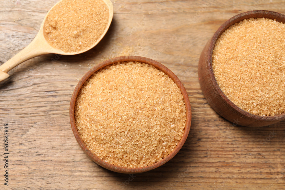 Different dishes with brown sugar on wooden table, flat lay Different dishes with brown sugar on wooden table, flat lay