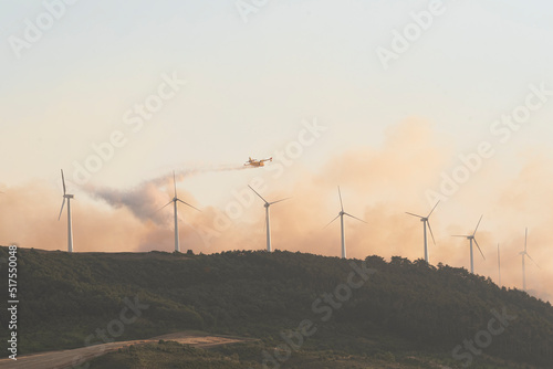 firefighters in canadair fire extinguisher fighting flames in the forest photo