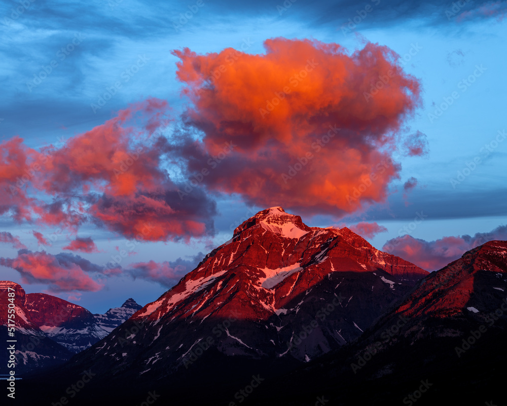 Beautiful sunrise clouds over Montana rocky mountain peak