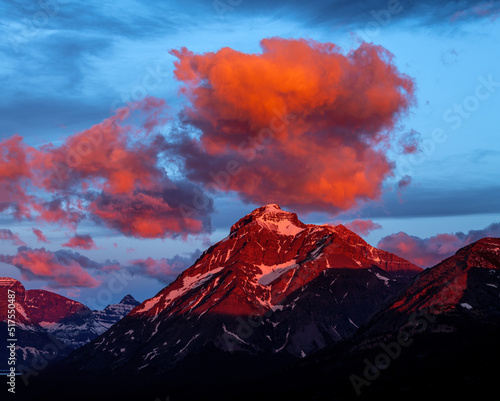 Beautiful sunrise clouds over Montana rocky mountain peak photo