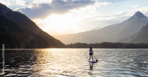Adventurous Woman Paddle Boarding in a Lake around Canadian Mountain Landscape. Chilliwack Lake  British Columbia  Canada. Adventure Sport Travel