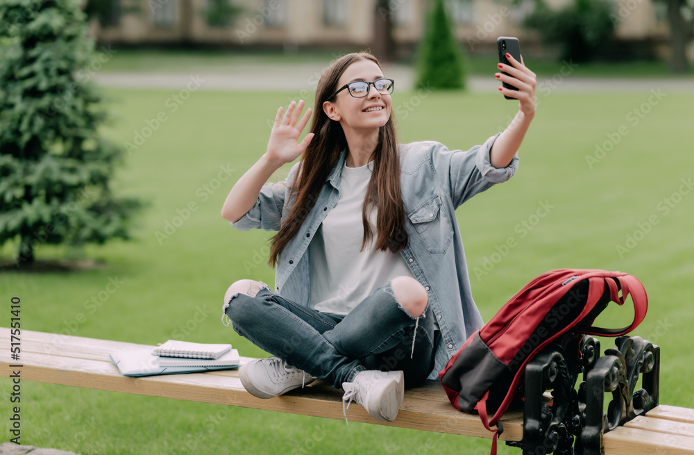 Cute student girl near campus taking selfie and live streaming video on social media Cute student girl near campus taking selfie and live streaming video on social media