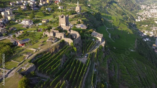 Aerial View - Terraced vineyards in the hills of Valtellina planted near monuments and old medieval ruins - Sondrio, Lombardy, Italy