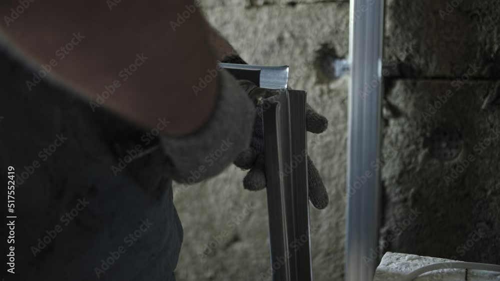 worker cuts metal profile with scissors worker cuts metal profile with scissors