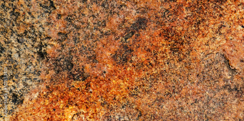 The texture of stone wall corrosion or grunge stone texture use for web design and wallpaper background. Surface of ancient rock layers brown, yellow, red