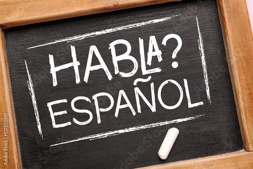 Chalkboard with text HABLA ESPANOL? (DO YOU SPEAK SPANISH?), closeup photo