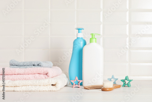 Set of baby toiletries, child organic hygiene and bath accessories, shower gel, shampoo, essential oil, towel in the bathroom
