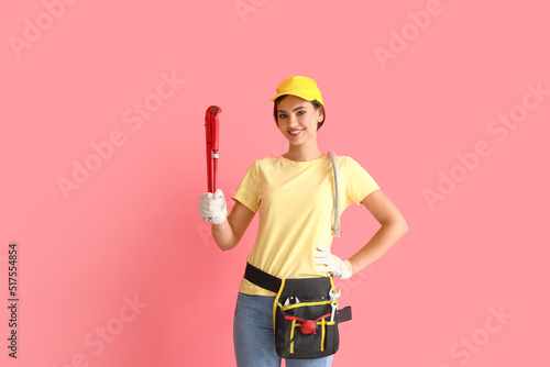 Female plumber with pipe wr...