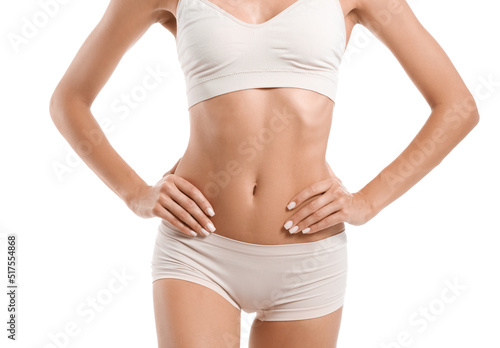 Young tanned woman in underwear on white background, closeup