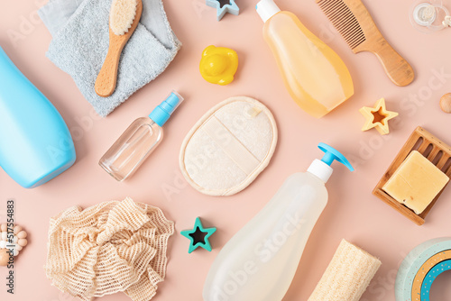 Fotografiet Set of baby toiletries, child organic hygiene and bath accessories, shower gel, shampoo, essential oil, towel on pink pastel background