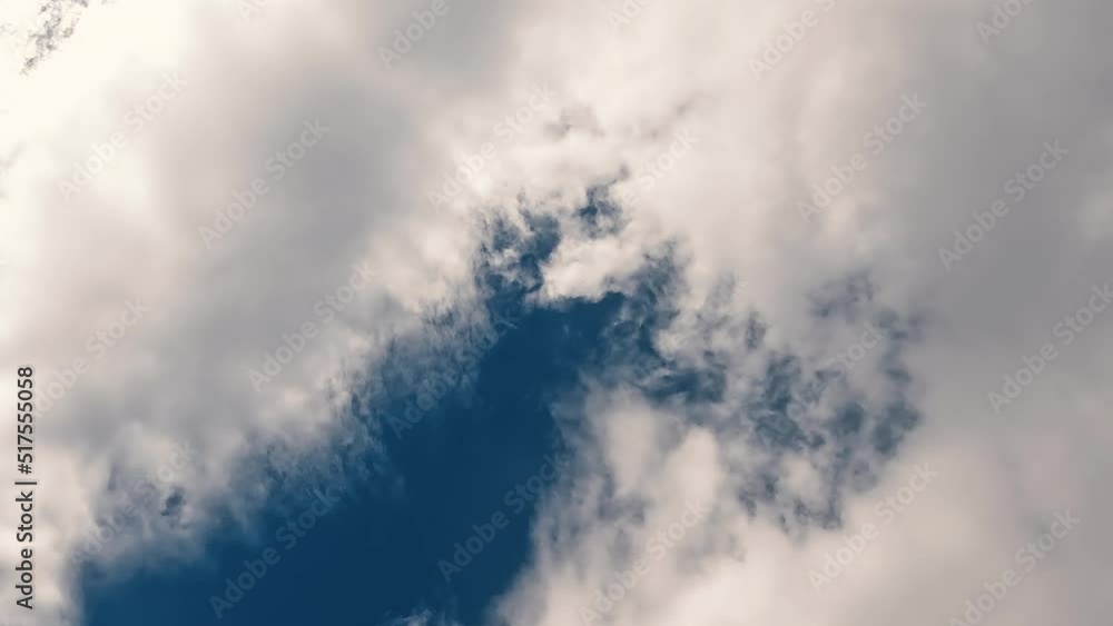 Cotton Ball Cumulus Clouds reach across the expansive blue sky. Day time sunshine peeks through the fluffy white clouds. Cotton Ball Cumulus Clouds reach across the expansive blue sky. Day time sunshine peeks through the fluffy white clouds.