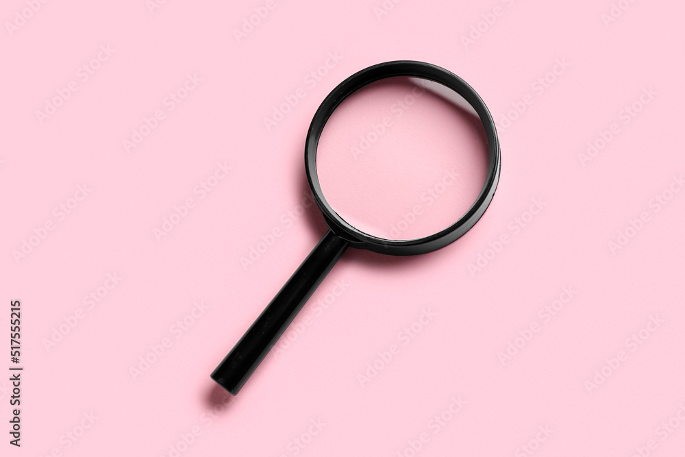 Magnifying glass on pink background Magnifying glass on pink background