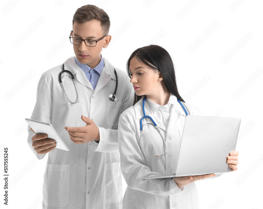 Medical assistants with laptop and tablet computer on white background