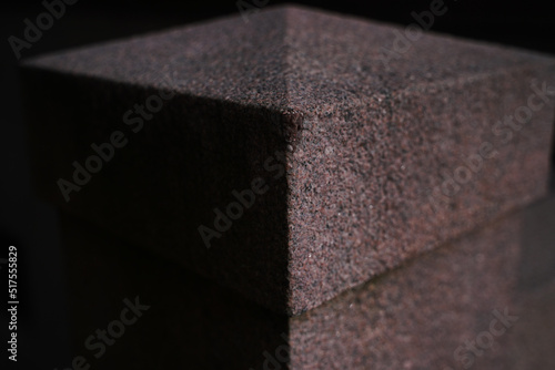 Granite figure made of red granite. Abstract background. Selective focus. High quality photo