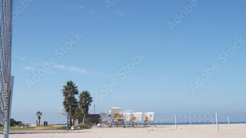 Wallpaper Mural Volley ball net on court for volleyball game on beach, California coast, USA. Sport field or playground for players on sandy ocean shore, lifeguard station and palm trees on Mission beach, San Diego. Torontodigital.ca