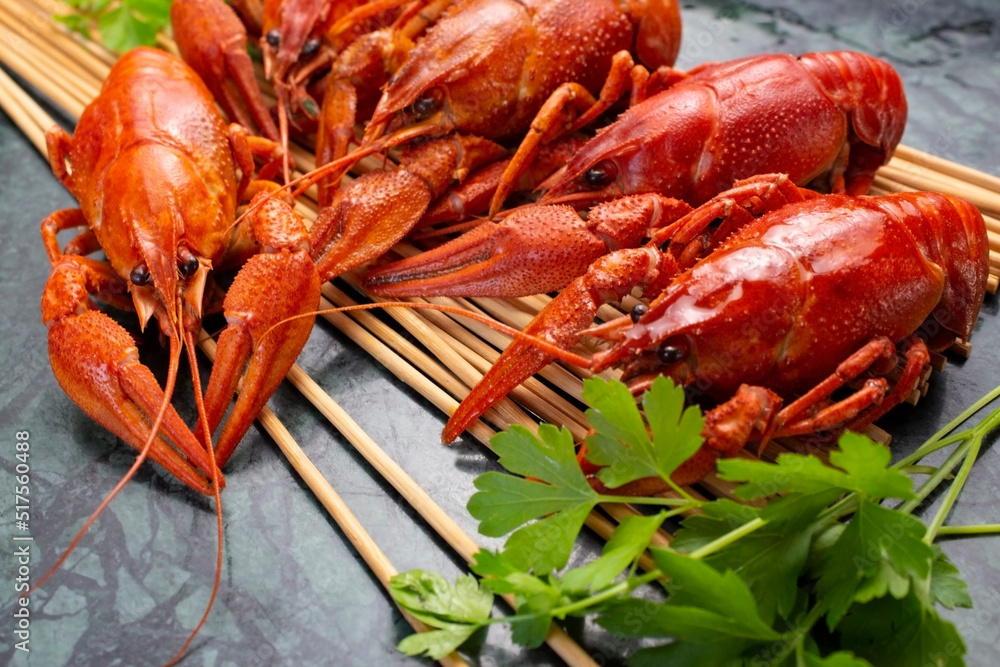 Fresh boiled red crayfish on a wooden stand with parsley. Great snack for beer. Fresh boiled red crayfish on a wooden stand with parsley. Great snack for beer.