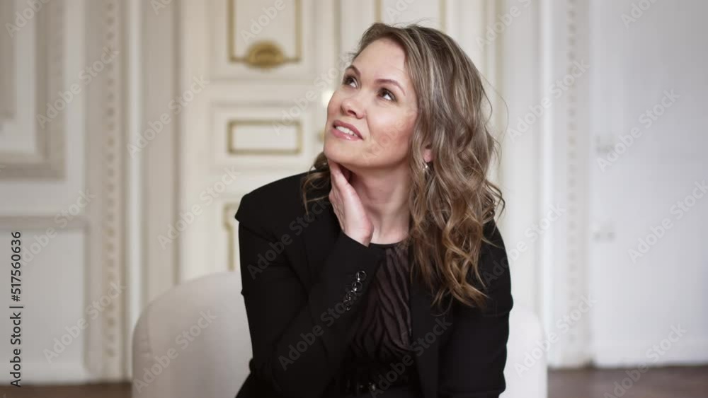 a funny and attractive woman in a black suit is having fun. a funny and attractive woman in a black suit is having fun.