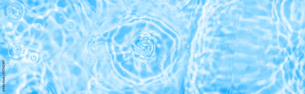Water panoramic banner background. Water texture, water surface with rings and ripple. Spa concept background. Flat lay, top view, copy space, composition Water panoramic banner background. Water texture, water surface with rings and ripple. Spa concept background. Flat lay, top view, copy space, composition