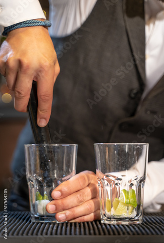 Wallpaper Mural Elegant barman making cocktail Mojito in night club adding ingredients and creating expert drinks on bar counter. Torontodigital.ca