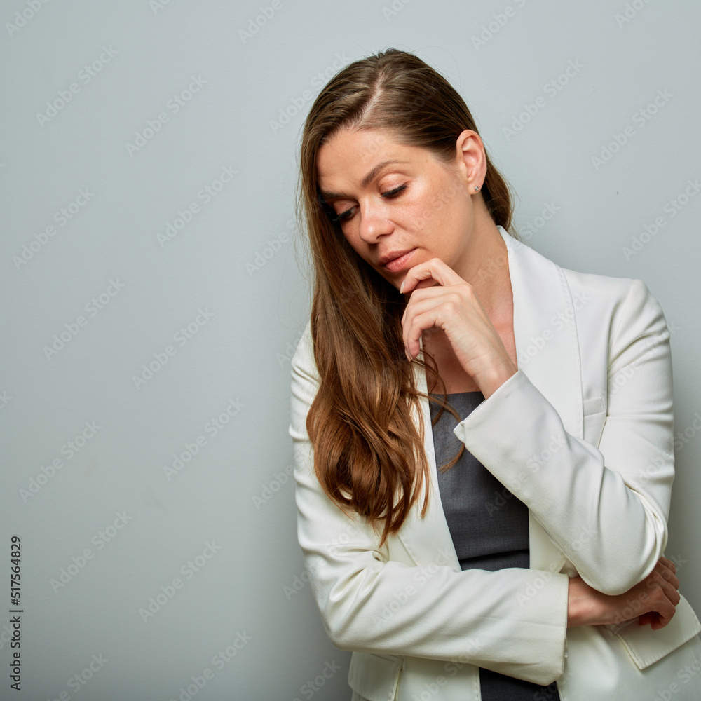 Serious business woman in white business suit looking down. isolated female portrait. Serious business woman in white business suit looking down. isolated female portrait.