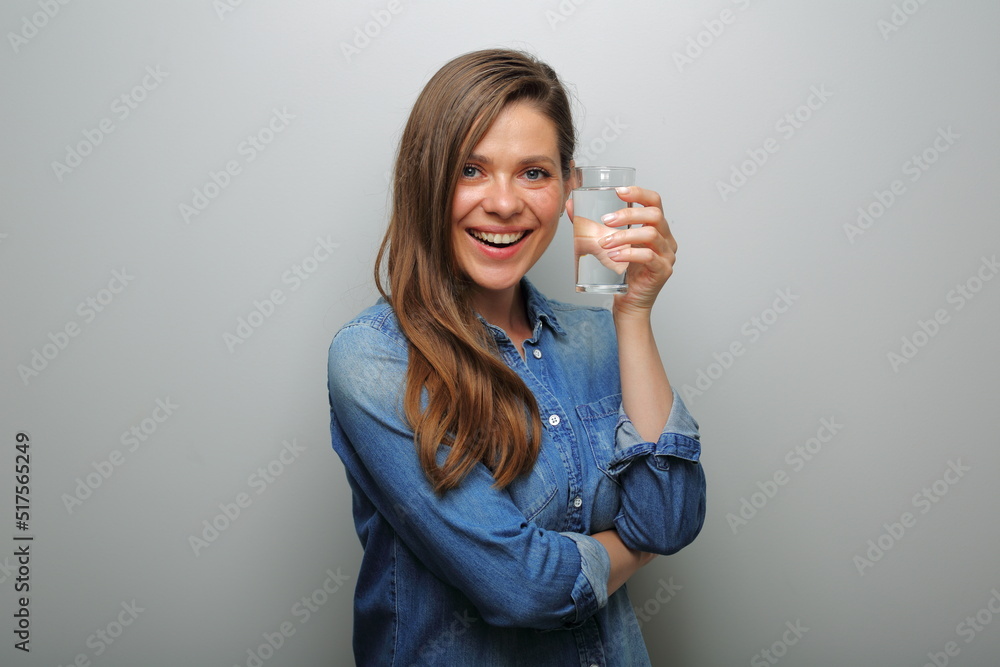 Water with clear glass smiling woman holding near her face. isolated female portrait. Water with clear glass smiling woman holding near her face. isolated female portrait.