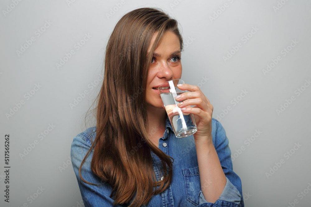 woman drink water and looking away. isolated female portrait. woman drink water and looking away. isolated female portrait.