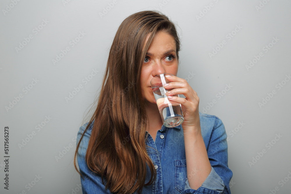 woman drink water and looking away. isolated female portrait. woman drink water and looking away. isolated female portrait.