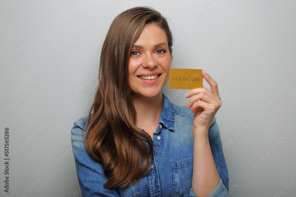 Smiling woman holding credit card near face. isolated female portrait. Smiling woman holding credit card near face. isolated female portrait.