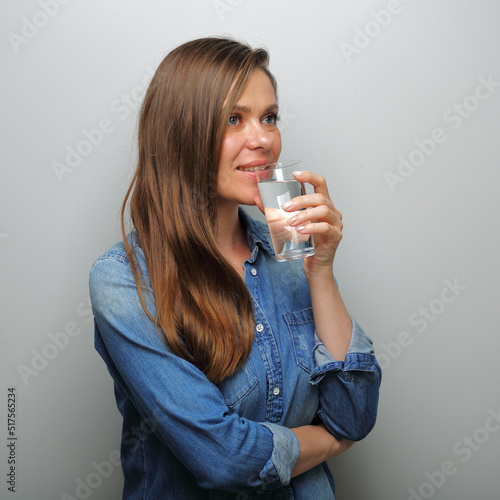 woman drink water and looking away. isolated female portrait.