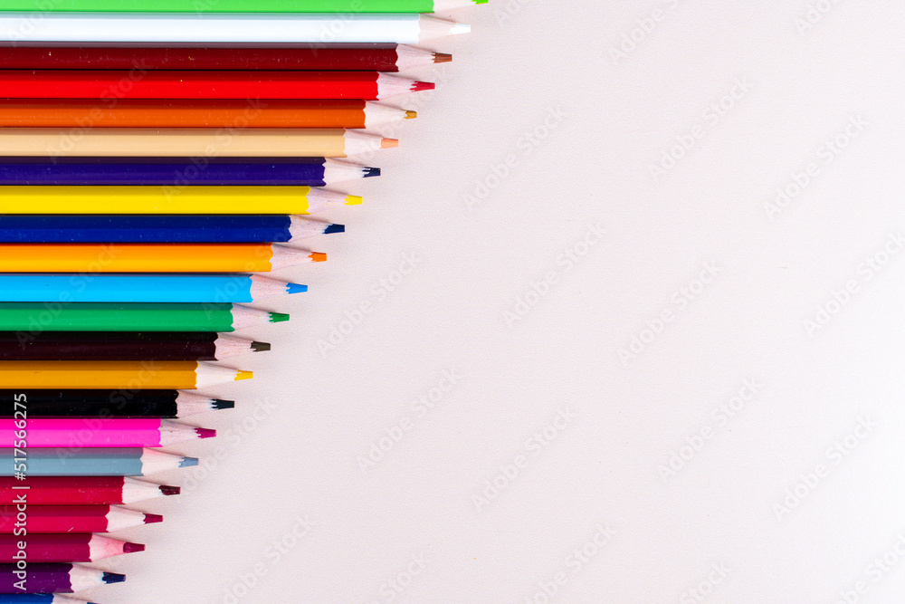 Plain background and pencils of different colors lined up Plain background and pencils of different colors lined up