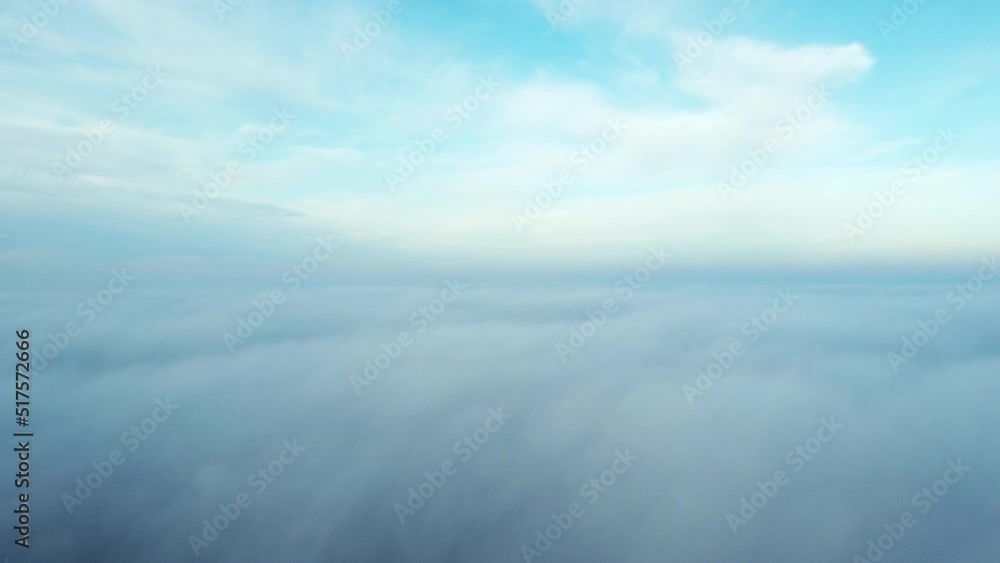 Aerial drone view flight over fog. Flight between white fluffy fog mist and clouds in blue sky on sunny day. Natural abstract background. Cloudy weather. Atmosphere. Top view fog movement. Timelapse. Aerial drone view flight over fog. Flight between white fluffy fog mist and clouds in blue sky on sunny day. Natural abstract background. Cloudy weather. Atmosphere. Top view fog movement. Timelapse.