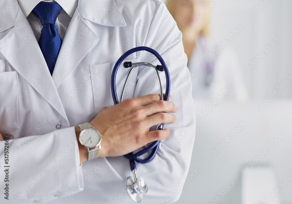 Young and confident male doctor with stethoscope in his hands. Successful doctor career concept Young and confident male doctor with stethoscope in his hands. Successful doctor career concept