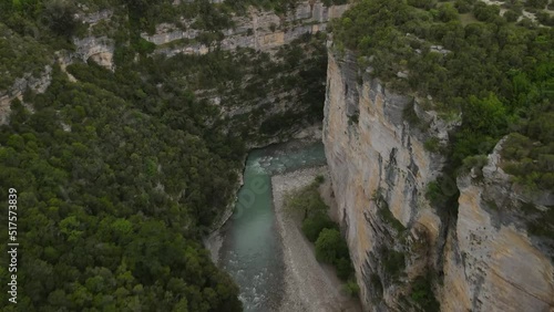 High rocky cliffs and natural rock formations of the Osum gorge (Kanionet e Osumit) with dense green foliage. photo