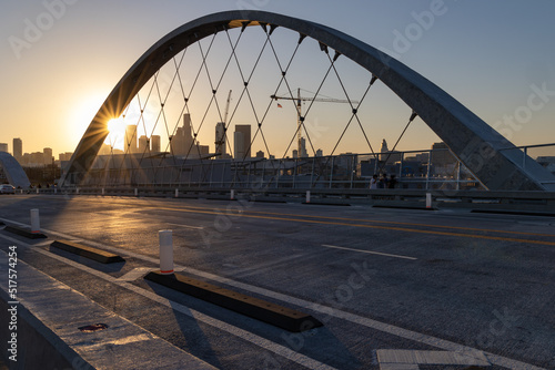 Lens flare at sunset on the 6th street bridge in Los Angeles with the skyline in the distance photo