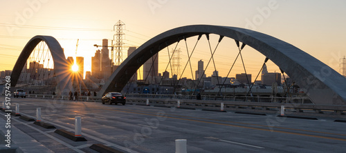 Lens flare at sunset on the 6th street bridge in Los Angeles with the skyline in the distance
