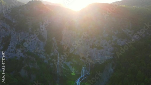 Ujevara E Sotires waterfalls near the village of Progonat. aerial drone view Ujevara E Sotires wild waterfalls in Nivica Canyon with cliffs of karst gorge with pool. natural landscape of waterfalls. photo