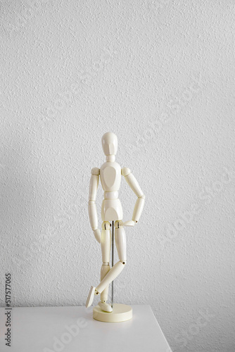 Obraz na plátne White wooden mannequin stands on the white table
