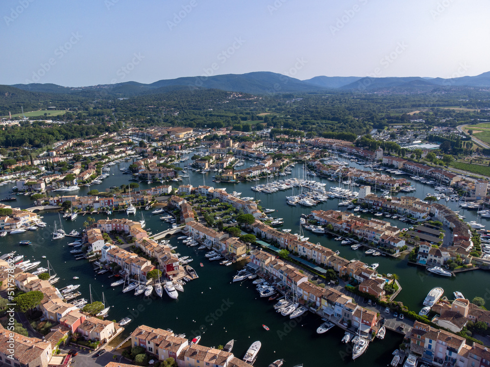 Obraz premium Aerial view on Gulf of Saint-Tropez, sail boats, houses of Port Grimaud and Port Cogolin, summer vacation in Provence, France