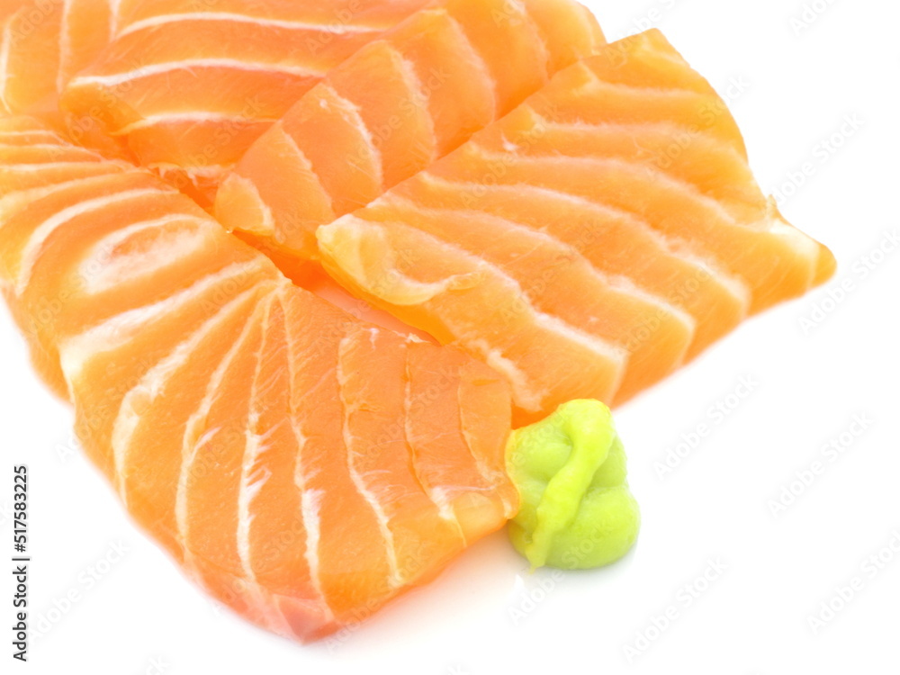 Pieces of fresh salmon slice and wasabi on white background