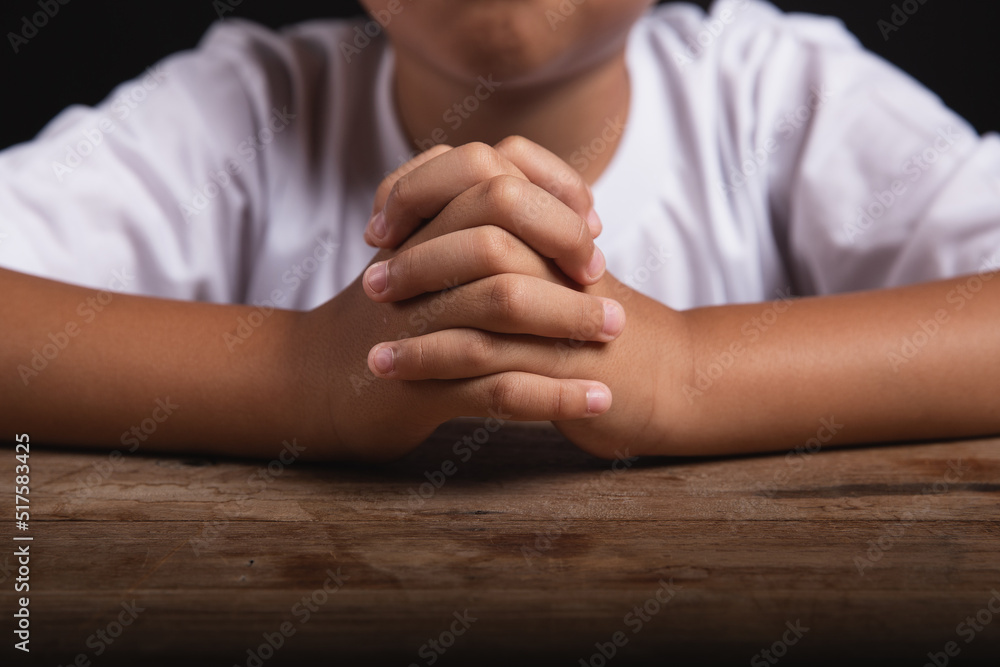 Boy praying to God at home