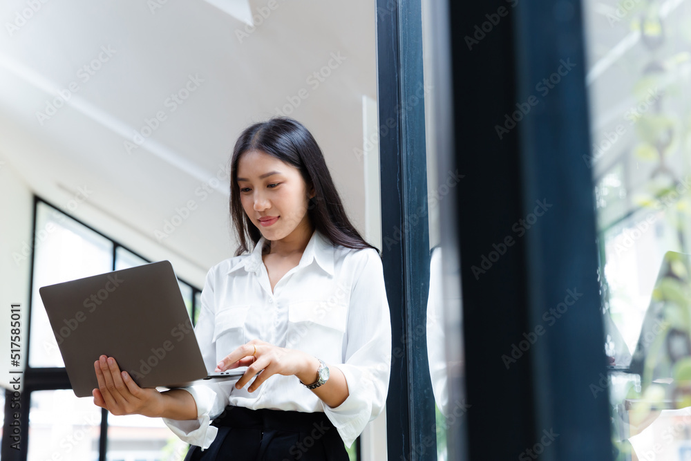 Asian businesswoman working with laptop at office.