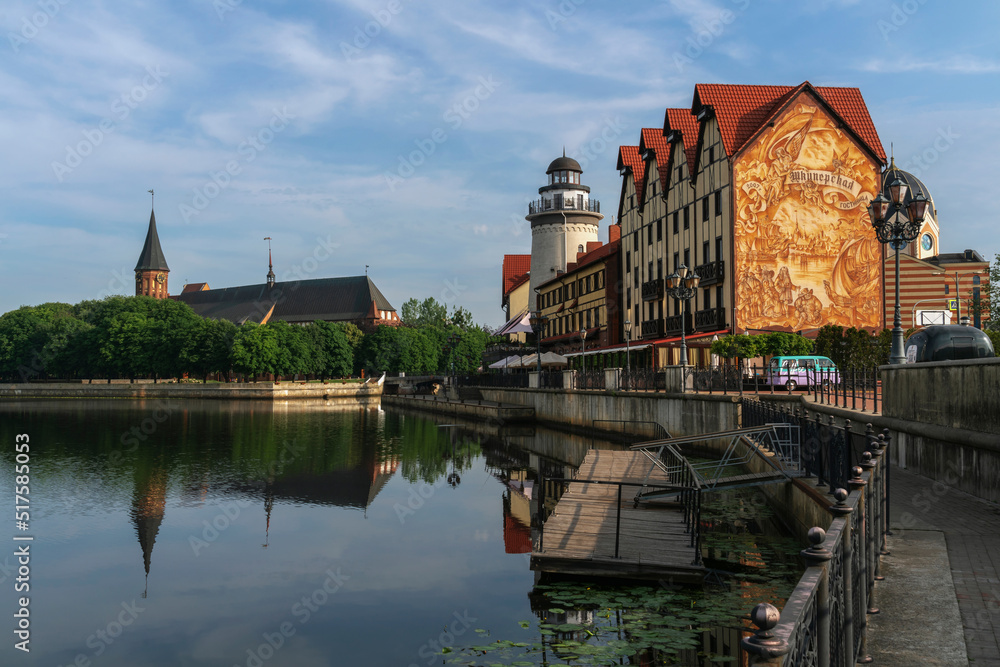 Obraz premium View of the fishing village on the embankment of the Pregolya River on a sunny summer day, Kaliningrad, Russia