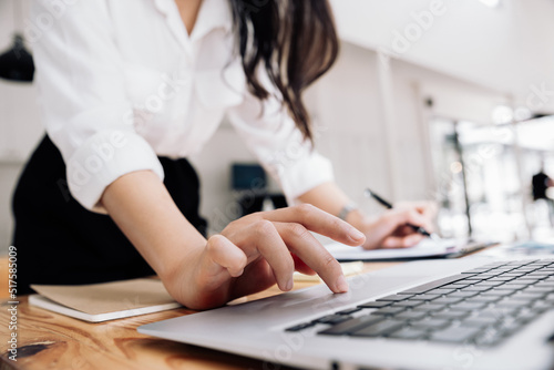 Asian businesswoman working with laptop at office.