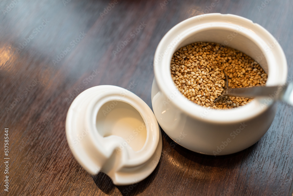 sesame seeds and a wooden dark table. Copy space. sesame seeds and a wooden dark table. Copy space.