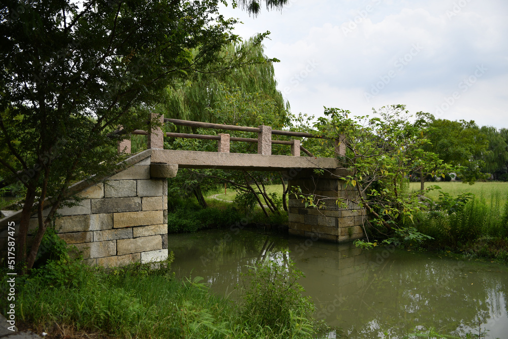 an old stone bridge over a small river