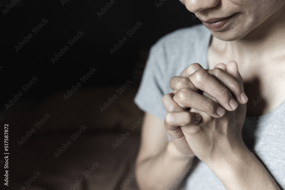 Hand of woman while praying for christian religion, Casual woman praying with her hands together to think of a loving God, we praise God.